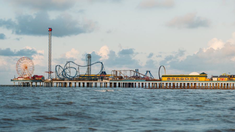 An amusement park on a pier over the water
