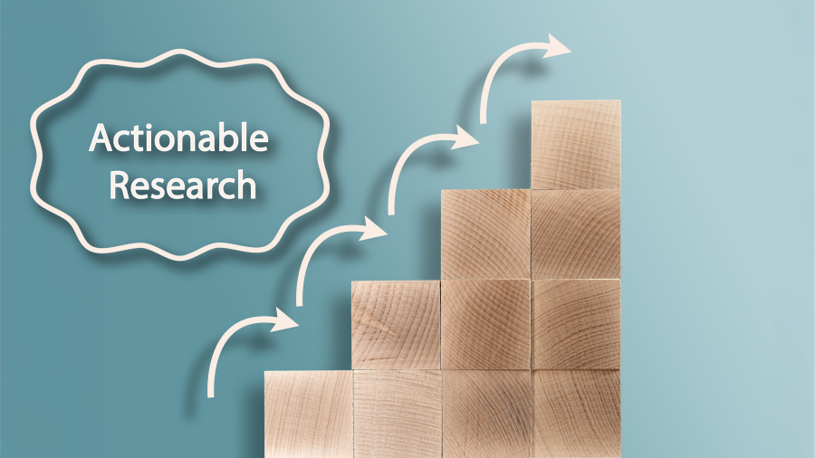 An image showing steps made from wooden blocks with white arrows going from one step to the next. On the left is the text "Actionable Research."