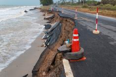 A photo showing the erosion of a road due to sea level rise